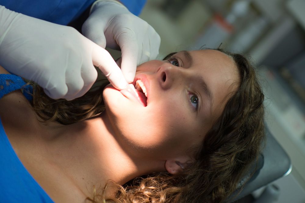 woman receiving oral cancer screening